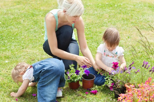 Trainer demonstrating safe equipment use to gardeners